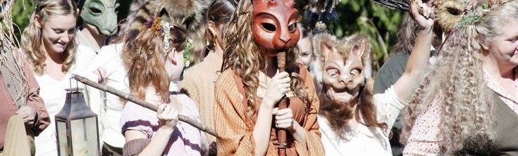 A procession of people wearing animal masks.