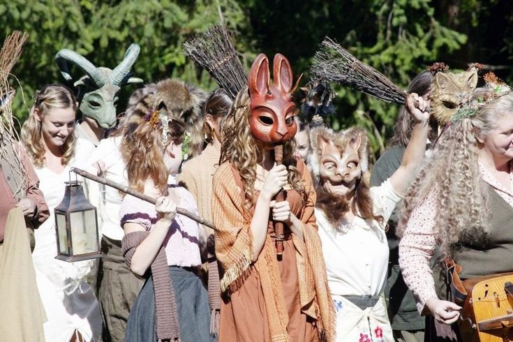 A procession of people wearing animal masks.
